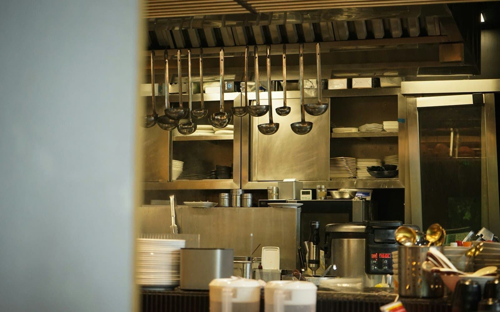 Kitchen utensils hang in a professional kitchen