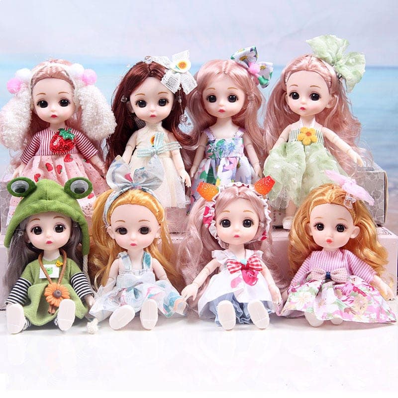 Assorted children's dolls in colourful dresses and character outfits arranged together
