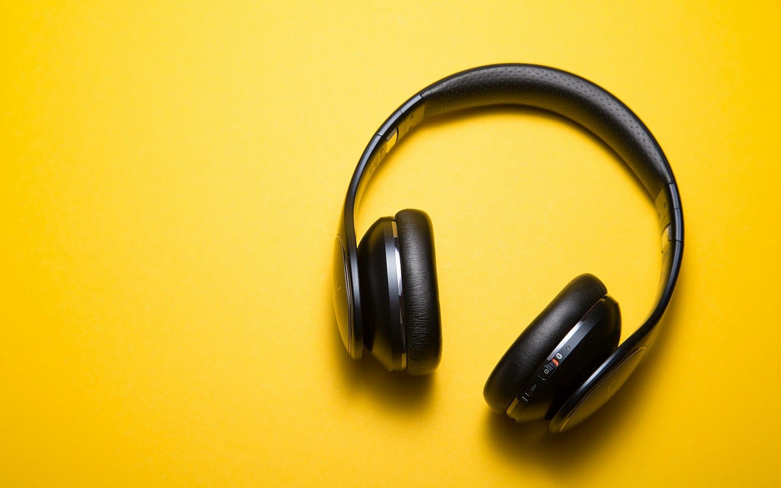 flatlay photography of wireless headphones
