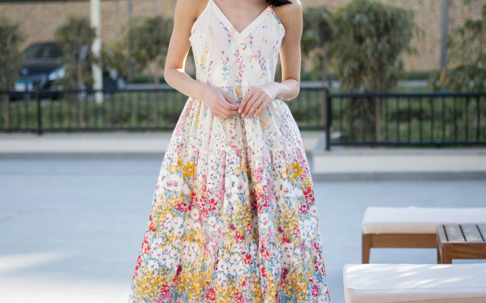 Floral sleeveless casual dress shown outdoors.