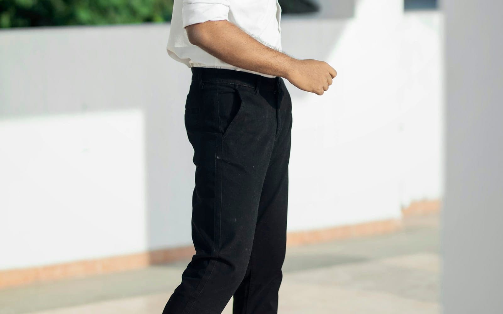 Black tailored trousers worn with a white shirt.