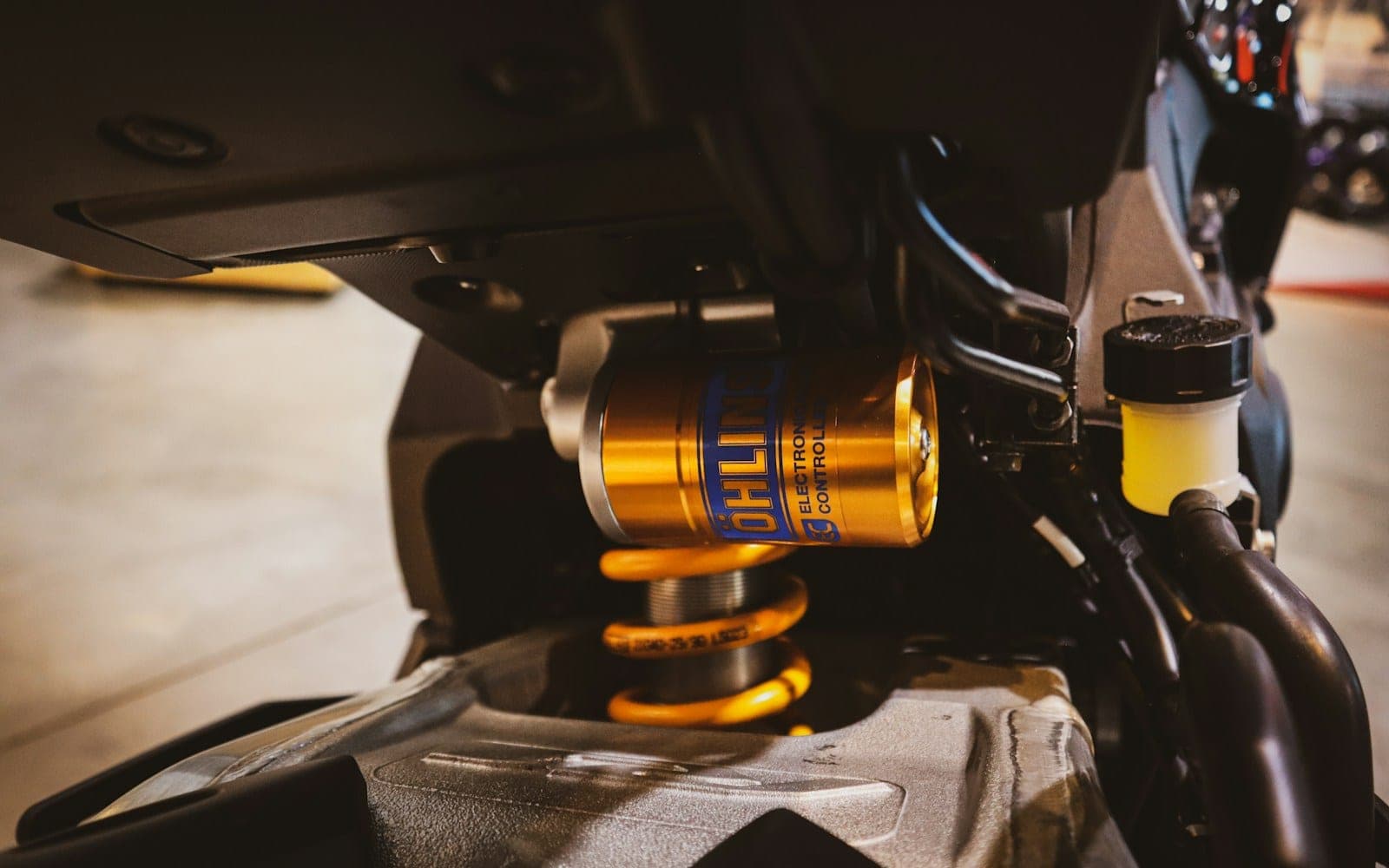 Golden motorcycle suspension with yellow spring detail